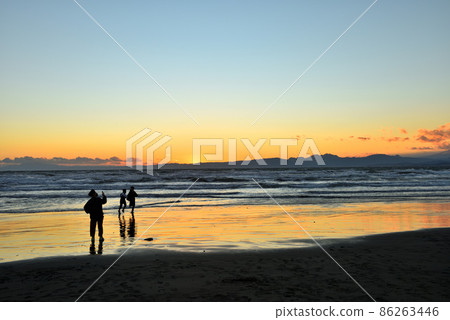 Children playing at the sunset and the beach at Katase Nishihama Beach 86263446