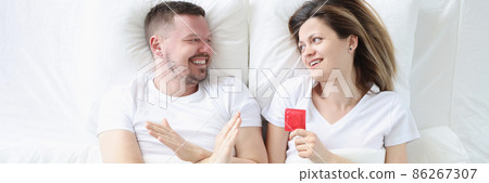 Man refuses to use condoms while lying in bed with woman Man refuses to use condoms while lying in bed with woman 86267307