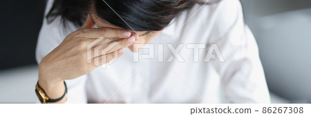 Tired depressed woman sits over plastic bank cards and calculator top view Tired depressed woman sits over plastic bank cards and calculator top view 86267308
