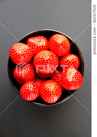 Strawberries in a bowl. Black background Strawberries in a bowl. Black background 86267926