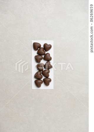 Chocolate hearts on a light background on Valentine's day Chocolate hearts on a light background on Valentine's day 86269659