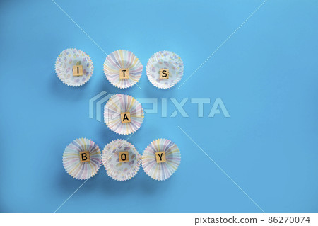 Its a boy text with wooden letters on blue background, Baby boy birth,new life,family Greeting card for newborn. with copy space 86270074