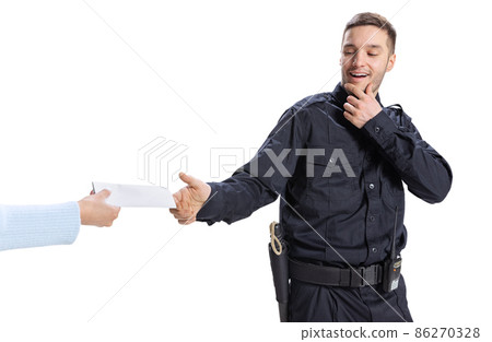Portrait of young man, policeman wearing black uniform refuses a bribe isolated on white background. Concept of job, caree, law and order. Portrait of young man, policeman wearing black uniform refuses a bribe isolated on white background. Concept of job, caree, law and order. 86270328