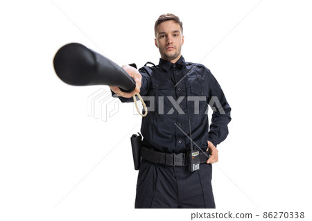 Front camera view. Young male policeman officer wearing black uniform looking at camera isolated on white background. Concept of job, caree, law and order. Front camera view. Young male policeman officer wearing black uniform looking at camera isolated on white background. Concept of job, caree, law and order. 86270338