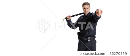 Flyer with young male policeman officer wearing black uniform posing isolated on white background. Concept of job, caree, law and order. 86270339