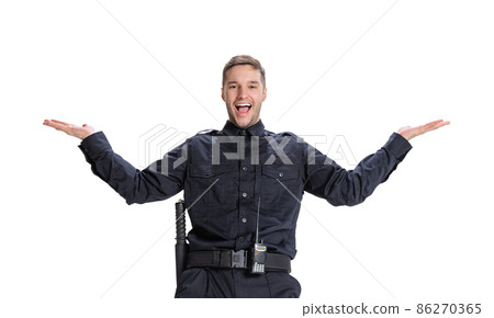 Studio shot young happy man, policeman officer wearing black uniform posing isolated on white background. Concept of job, caree, law and order. Studio shot young happy man, policeman officer wearing black uniform posing isolated on white background. Concept of job, caree, law and order. 86270365