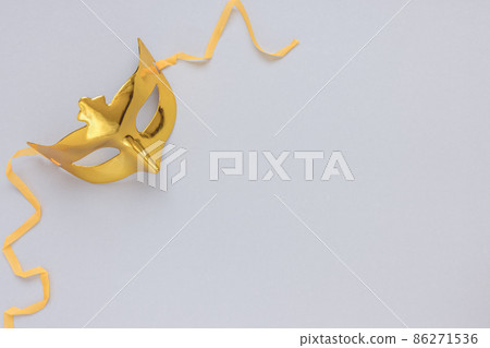 Gold carnival mask on gray background. Carnival season, celebration, costume party concept 86271536