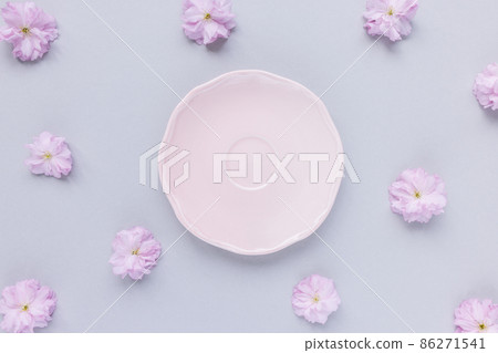 Pink saucer or dessert plate and fresh spring cherry blossom flowers Pink saucer or dessert plate and fresh spring cherry blossom flowers 86271541