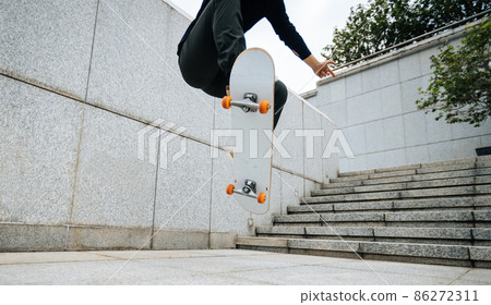 Skateboarder skateboarding outdoors in city Skateboarder skateboarding outdoors in city 86272311