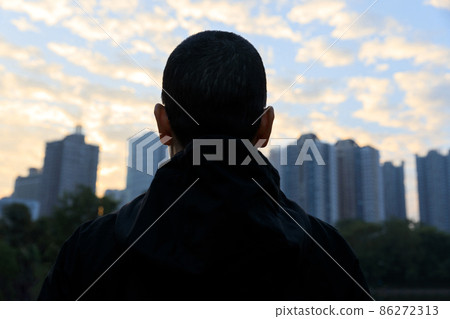 Focused bald woman looking forward in city 86272313