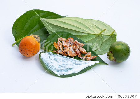 Chewing betel nut, Betel nut with cal lime powder on betel leaves 86273307