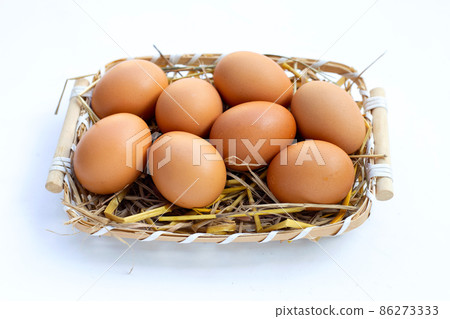 Fresh organic eggs in a straw nest Fresh organic eggs in a straw nest 86273333