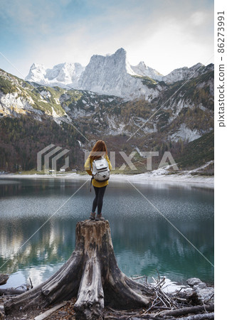 beautiful girl sitting on a stump 86273991