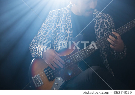 Beard person playing the guitar Beard person playing the guitar 86274039