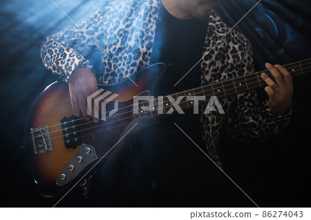 Beard person playing the guitar Beard person playing the guitar 86274043