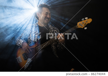 Beard person playing the guitar Beard person playing the guitar 86274044