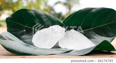 Cubes of alum on tree leaves with blur trees background. Soft and selective focus on alum. Cubes of alum on tree leaves with blur trees background. Soft and selective focus on alum. 86274785