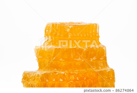 Fresh cut comb honey isolated on white Fresh cut comb honey isolated on white 86274864
