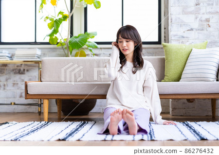 一個年輕的女人在客廳裡放鬆 一個年輕的女人在客廳裡放鬆 86276432
