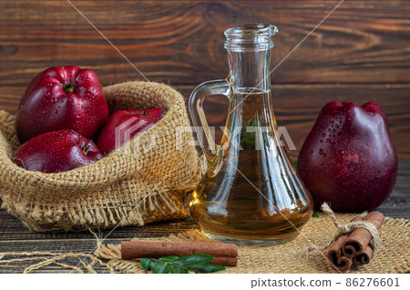 Apple cider vinegar and red apples on a dark, wooden background. Selective focus. fermented product. Healthy food. 86276601
