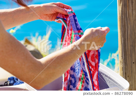 Female washing laundry on holidays trip. Female washing laundry on holidays trip. 86278090