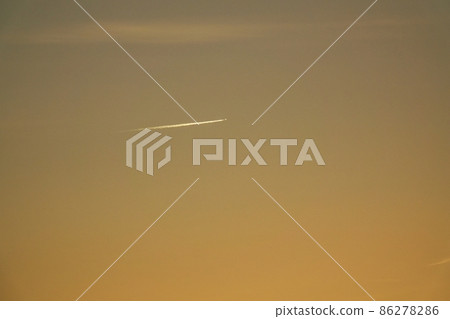 Winter morning sky, contrails illuminated by the morning sun, sky subject, telephoto Winter morning sky, contrails illuminated by the morning sun, sky subject, telephoto 86278286