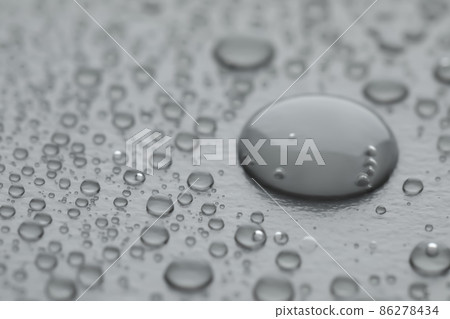 Water drops on grey background, closeup view Water drops on grey background, closeup view 86278434
