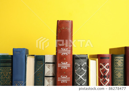 Collection of old books on yellow background Collection of old books on yellow background 86278477