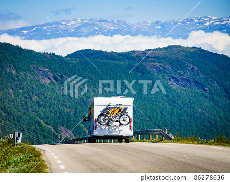 Camper car with bicycles on road Camper car with bicycles on road 86278636