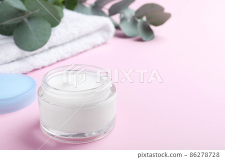 Open jar of cream on pink background. Space for text 86278728