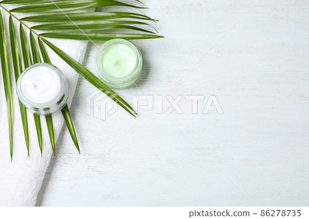 Flat lay composition with jars of cream on white wooden table. Space for text Flat lay composition with jars of cream on white wooden table. Space for text 86278735