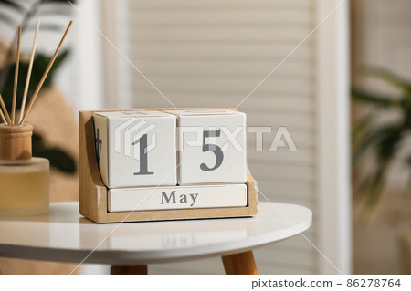 Wooden block calendar and aromatic reed air freshener on white table indoors Wooden block calendar and aromatic reed air freshener on white table indoors 86278764