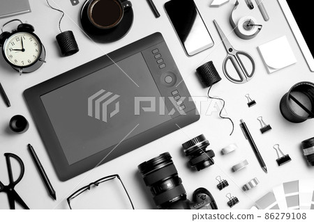 Flat lay composition with graphic drawing tablet and different office items on light background. Designer's workplace 86279108