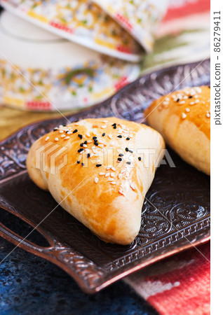Samsa, national savory baking, usually with minced meat, cheese or vegetables as a filling, an oriental meal, Central Asia cuisine concept. 86279411