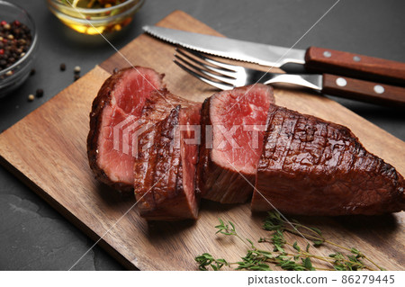 Delicious sliced beef tenderloin served on table, closeup Delicious sliced beef tenderloin served on table, closeup 86279445