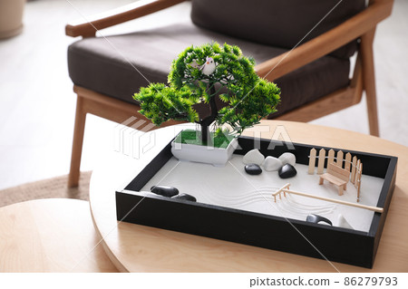 Beautiful miniature zen garden on wooden table indoors 86279793