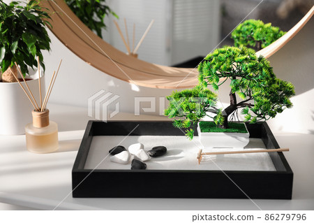 Beautiful miniature zen garden on white table indoors Beautiful miniature zen garden on white table indoors 86279796