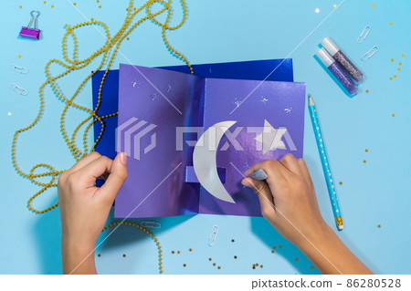 Diy Ramadan kareem card with silver crescent moon and a star. Gift idea, decor Ramadan kareem. Step by step. Top view. 86280528
