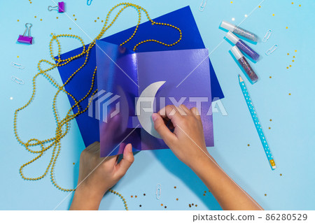 Diy Ramadan kareem card with silver crescent moon and a star. Gift idea, decor Ramadan kareem. Step by step. Top view. 86280529