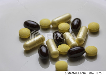 Granules of many types of supplements on a white plate Granules of many types of supplements on a white plate 86280759