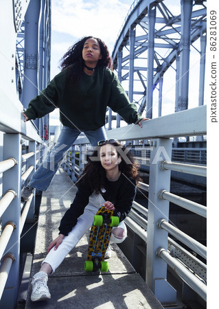 young cute teenage girls together in industrial zone happy smiling having fun, big city lifestyle fashion people 86281069