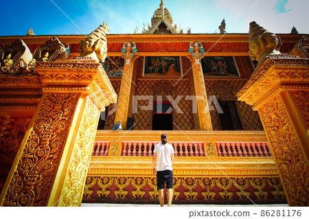 Low angle view of a tourist in front of Chua Phu Ly, a khmer Buddhist temple in Can tho, Vietnam Low angle view of a tourist in front of Chua Phu Ly, a khmer Buddhist temple in Can tho, Vietnam 86281176