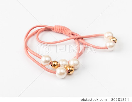 Hair band with pearls on a light background Hair band with pearls on a light background 86281854