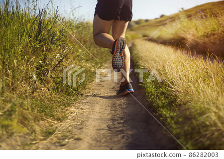 Man is training, running, warming up outdoor. 86282003