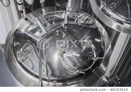 Modern Beer Factory. Steel tanks for beer fermentation and storage. Brewery. Modern beer plant with brewering kettles 86283624