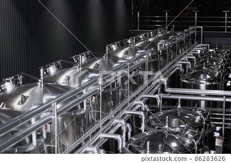Modern Beer Factory. Steel tanks for beer fermentation and storage. Brewery. Modern beer plant with brewering kettles Modern Beer Factory. Steel tanks for beer fermentation and storage. Brewery. Modern beer plant with brewering kettles 86283626