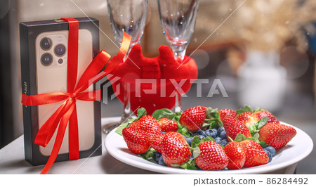 Blurred Valentine's Day composition with 13 iPhone strawberries red hearts on the table. In Love concept, couple relations Blurred Valentine's Day composition with 13 iPhone strawberries red hearts on the table. In Love concept, couple relations 86284492