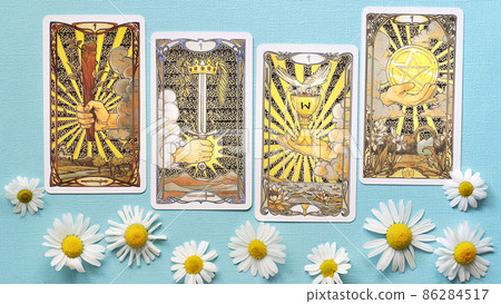 Golden tarot cards on the Blue background with Daisy flowers, four aces 86284517
