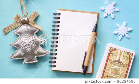 Winter composition with Tarot cards and snowflakes on the Blue background Winter composition with Tarot cards and snowflakes on the Blue background 86284595