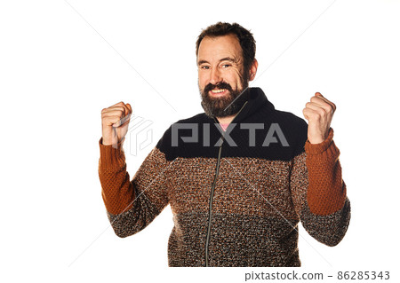 Happy and smiling Caucasian bearded man, making the victory sign with his hands. goal achieved. Happy and smiling Caucasian bearded man, making the victory sign with his hands. goal achieved. 86285343